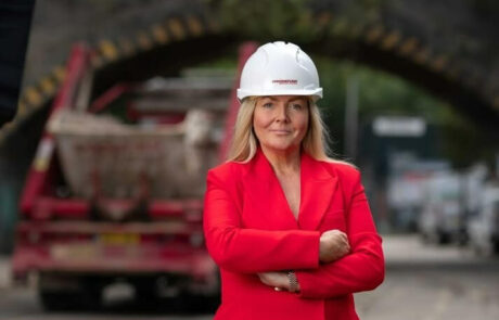 Jacqueline O'Donovan with helmet on and waste recycling vehicle behind